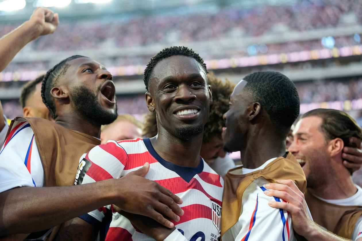 The United States' Folarin Balogun (center) — pictured celebrating a U.S. goal against Paraguay on Friday, June 12, 2026 — will be eligible to return for Monday's round of 16 matchup against Belgium. (Andre Penner/AP)
