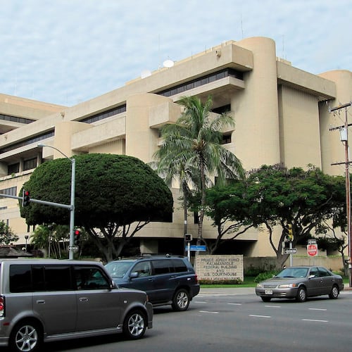 FILE - Cars pass in front of the federal building housing the U.S. District Court in Honolulu on March 7, 2014. (AP Photo/Jennifer Sinco Kelleher, File)