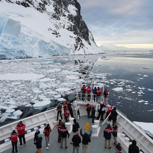 FILE - Passengers watch as a ship sails through the Lemaire Channel in Antarctica, Monday, Nov. 24, 2025. (AP Photo/Mark Baker, File)