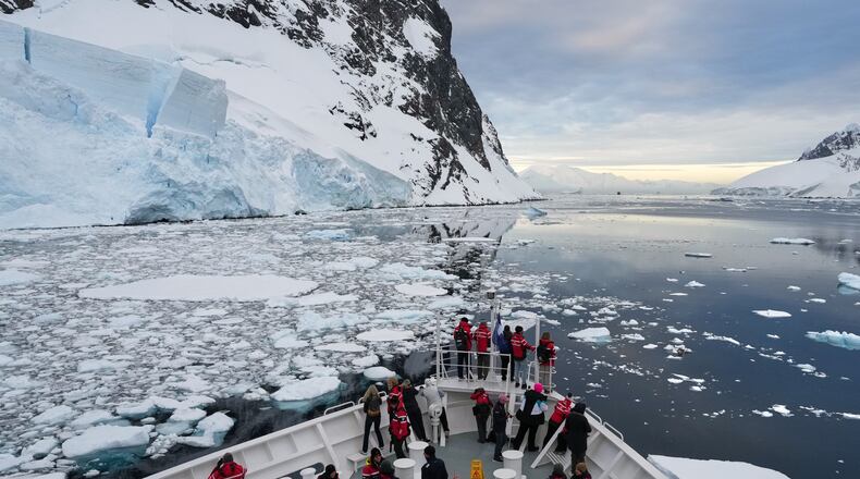 FILE - Passengers watch as a ship sails through the Lemaire Channel in Antarctica, Monday, Nov. 24, 2025. (AP Photo/Mark Baker, File)
