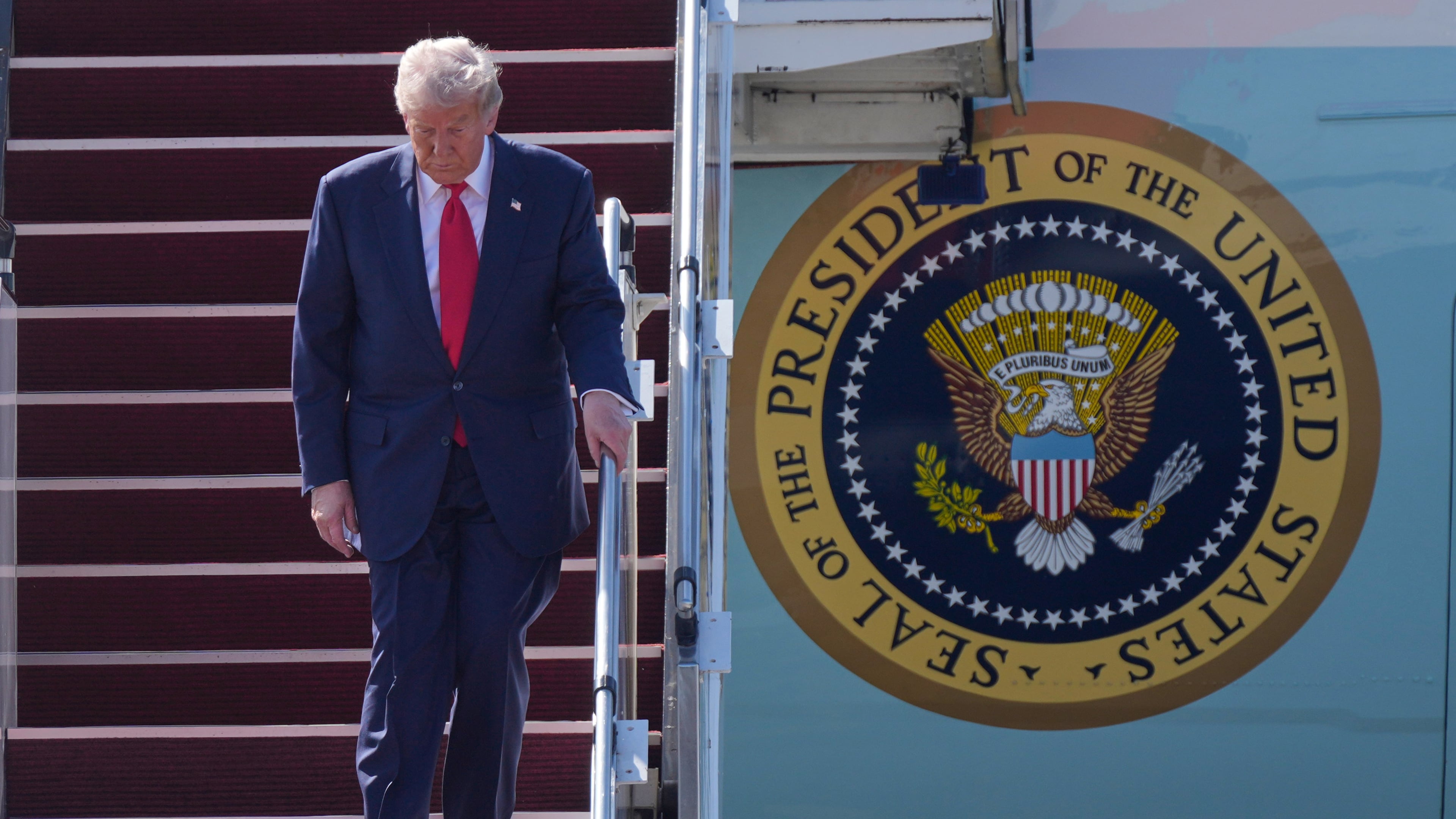President Donald Trump walks down the stairs of Air Force One as he arrives at Kuala Lumpur International Airport in Sepang, Malaysia, Sunday, Oct. 26, 2025. (AP Photo/Mark Schiefelbein)