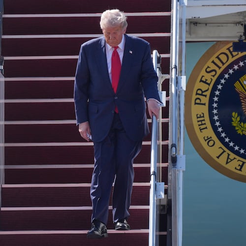 President Donald Trump walks down the stairs of Air Force One as he arrives at Kuala Lumpur International Airport in Sepang, Malaysia, Sunday, Oct. 26, 2025. (AP Photo/Mark Schiefelbein)