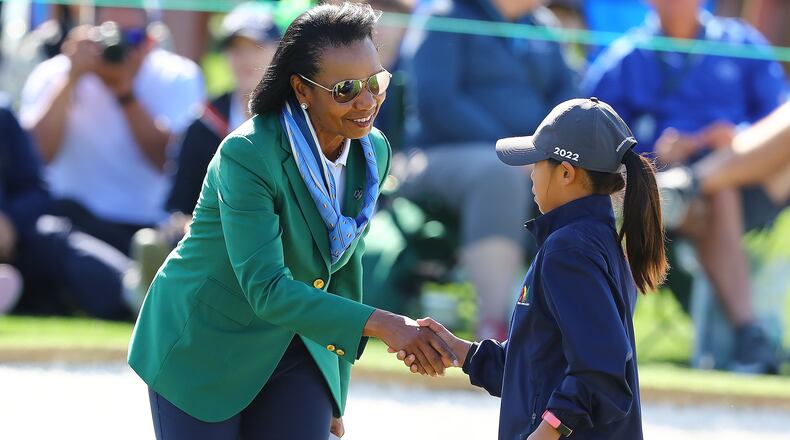 Kylie Chung, Suwanee, is greeted by former United States Secretary of State Condoleezza Rice on the 18th green after putting during the Drive, Chip and Putt National Finals at Augusta National Golf Club on Sunday, April 3, 2022, in Augusta. Curtis Compton / Curtis.Compton@ajc.com