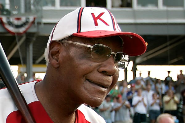 FILE - Buck O'Neil walks to the field as he is introduced before a minor league all-star game Tuesday, July 18, 2006, in Kansas City, Kan. (AP Photo/Charlie Riede, File)