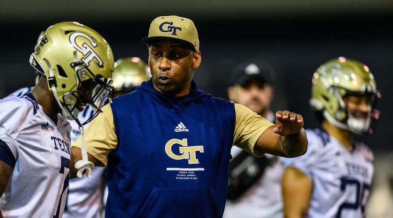 Georgia Tech secondary coach Travares Tillman speaks with Yellow Jackets cornerback Zamari Walton during spring practice in February 2022. (Danny Karnik/Georgia Tech Athletics)