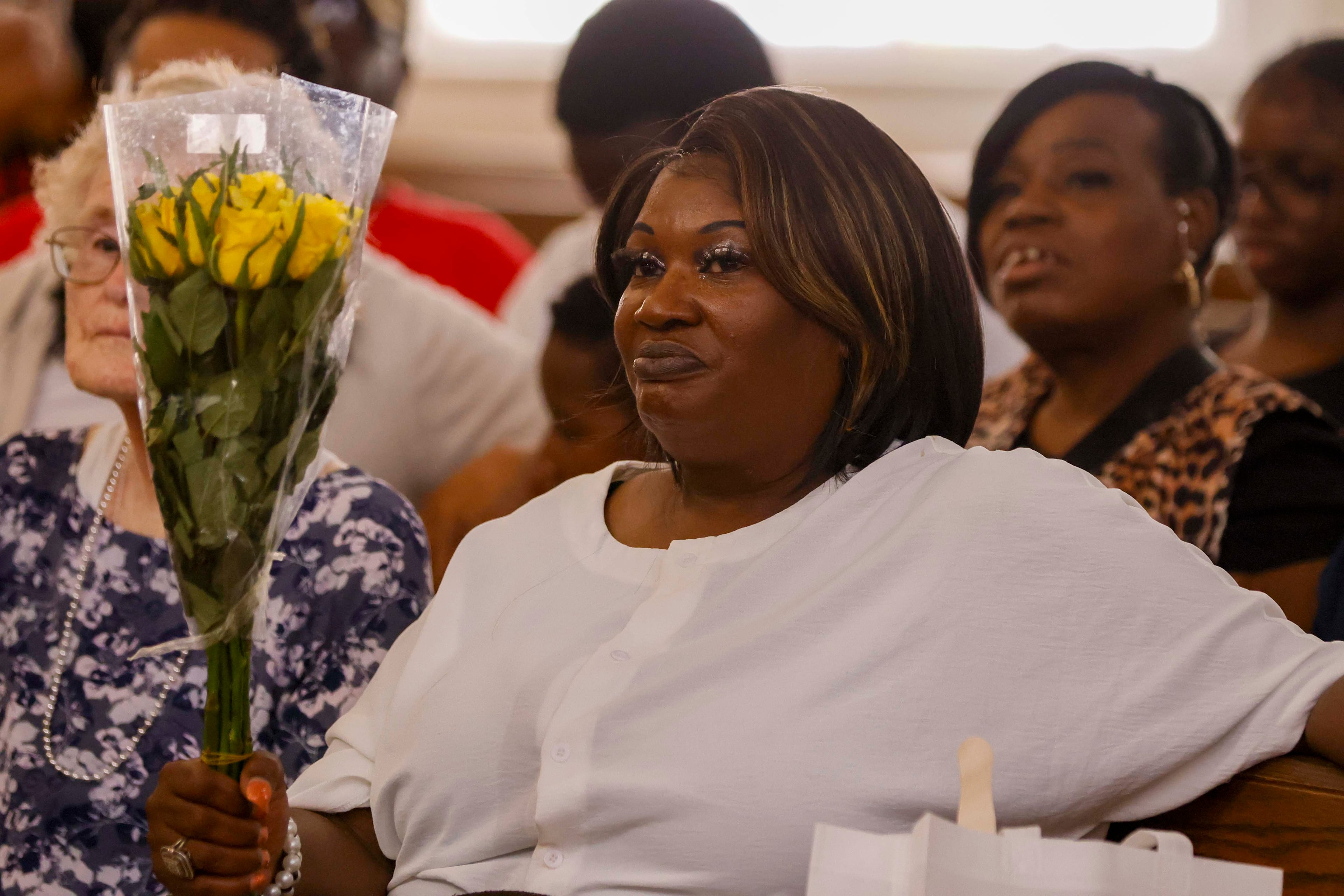 April Newkirk holds a bouquet during a vigil in honor of her daughter Adriana Smith at the Park Avenue Baptist Church on Sunday, June 15, 2025, in Atlanta. Adriana's family laid the 30-year-old mother to rest on Saturday, June 28. (Miguel Martinez/AJC)
