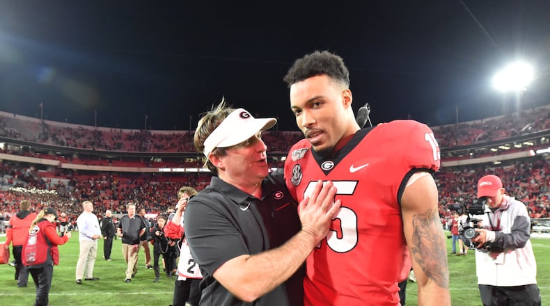 Georgia head coach Kirby Smart talks to receiver Lawrence Cager after a win over Texas A&M. (Hyosub Shin / Hyosub.Shin@ajc.com)