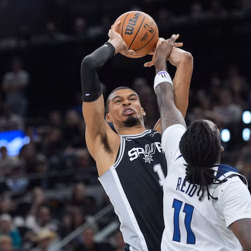 San Antonio Spurs forward Victor Wembanyama (1) grabs a rebound over Minnesota Timberwolves center Naz Reid (11) during the first half of Game 5 of an NBA basketball second-round playoffs series in Minneapolis, Tuesday, May 12, 2026. (AP Photo/Eric Gay)