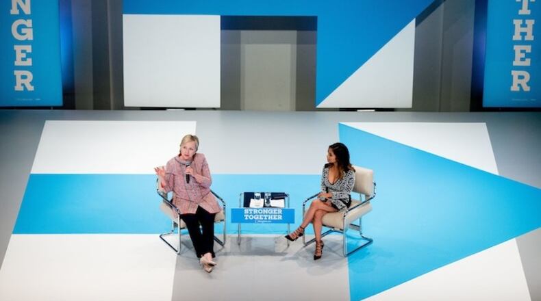 Democratic presidential candidate Hillary Clinton, accompanied by Dulce Candy, right, speaks at a Digital Content Creators Town Hall at the Neuehouse Hollywood in Los Angeles, Tuesday, June 28, 2016. (AP Photo/Andrew Harnik)