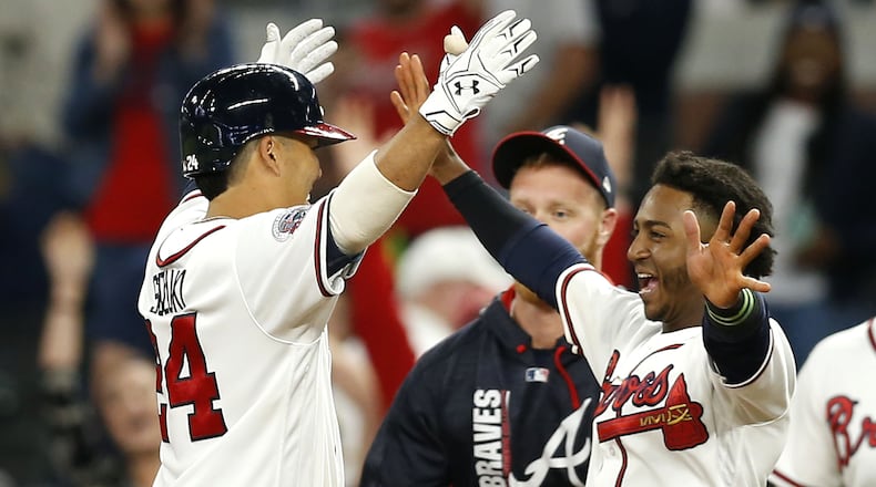 Catcher Kurt Suzuki #24 and second baseman Ozzie Albies #1 of the Atlanta Braves celebrate after Suzuki's game-winning, walkoff single in the ninth inning during the game against the Miami Marlins at SunTrust Park on September 7, 2017 in Atlanta, Georgia.  (Photo by Mike Zarrilli/Getty Images)