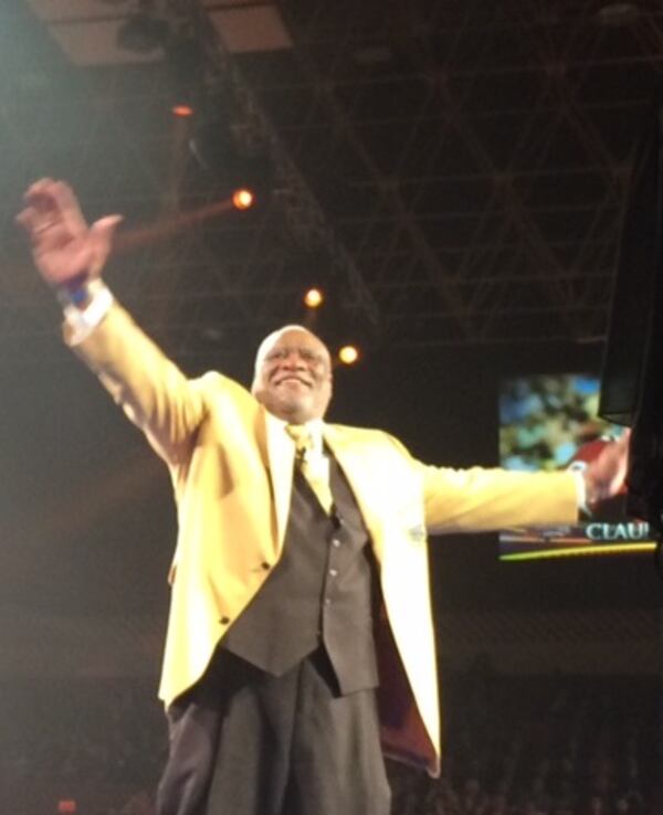 Former Falcons defensive end Claude Humphrey waving to the crowd after receiving his gold jacket on Friday at the Canton Civic Center. (By D. Orlando Ledbetter/DLedbetter@ajc.com)