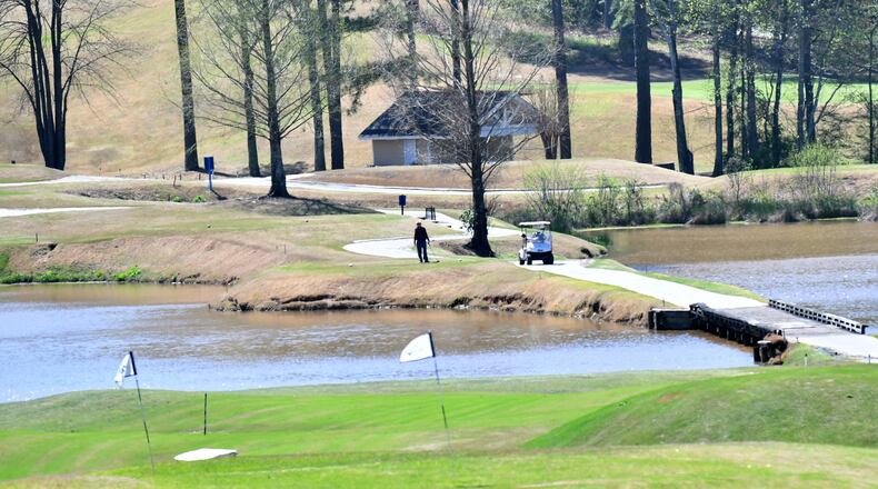 Golfers enjoy the sunny spring weather on the green at Heritage Golf Links in Tucker on Wednesday, March 25, 2020.  (Hyosub Shin / Hyosub.Shin@ajc.com)