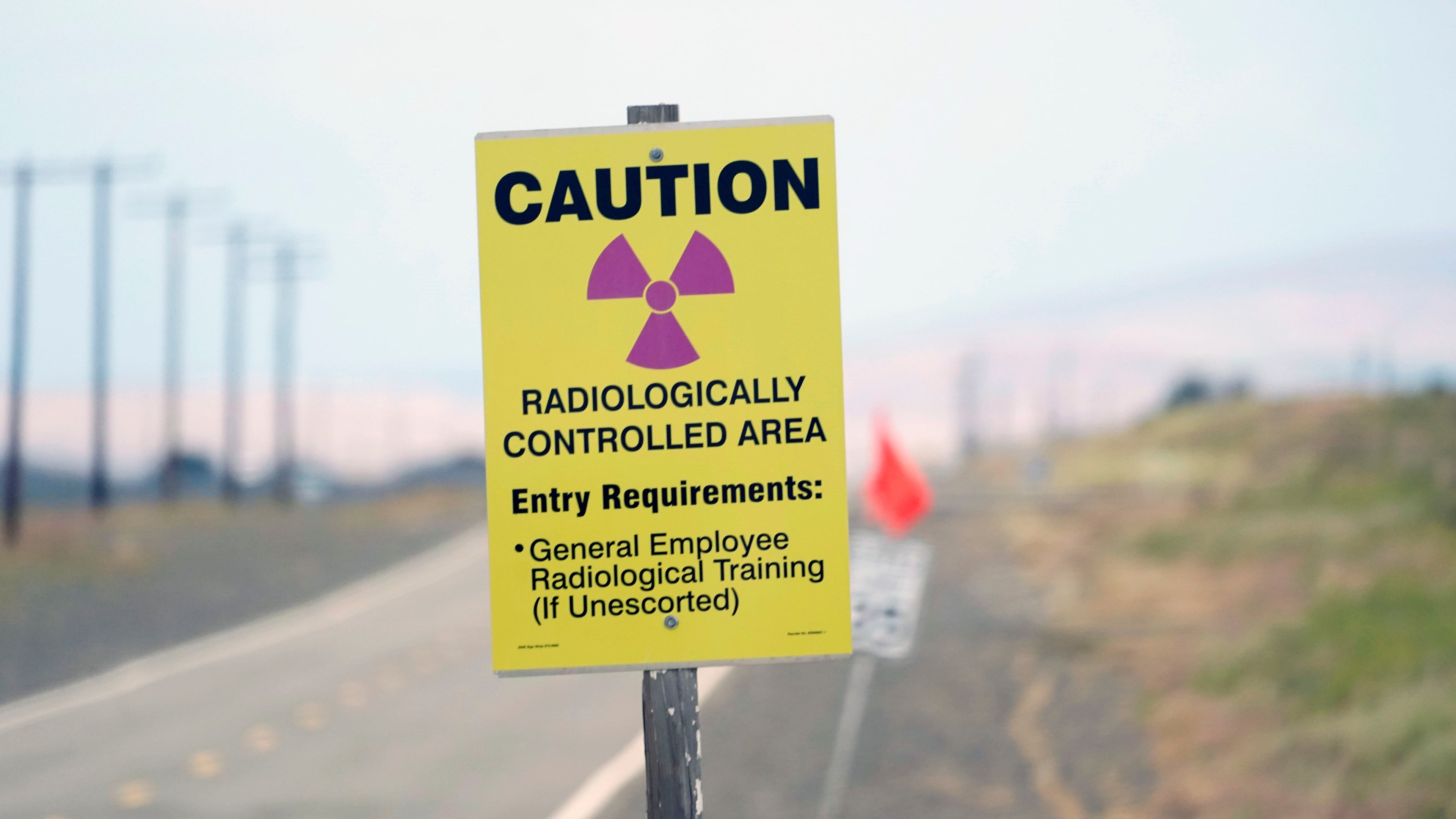 FILE - A caution sign is shown on a road on the Hanford Nuclear Reservation on June 2, 2022, in Richland, Wash. (AP Photo/Ted S. Warren, File)