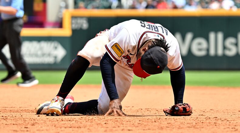 Braves second baseman Ozzie Albies rises after trying to catch a ball on August 2, 2023, in Atlanta. (Hyosub Shin / Hyosub.Shin@ajc.com)