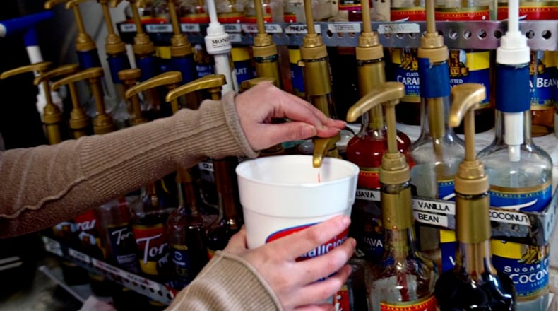 An employee adds syrup to a customer’s drink at Sodalicious, a soda shop, in Provo, Utah, Nov. 6, 2015. So-called “dirty” soda shops have woven themselves into the state’s fabric in recent years, but as they shops have proliferated, a fight has broken out between Sodalicious and Swig over the use of the word “dirty.”