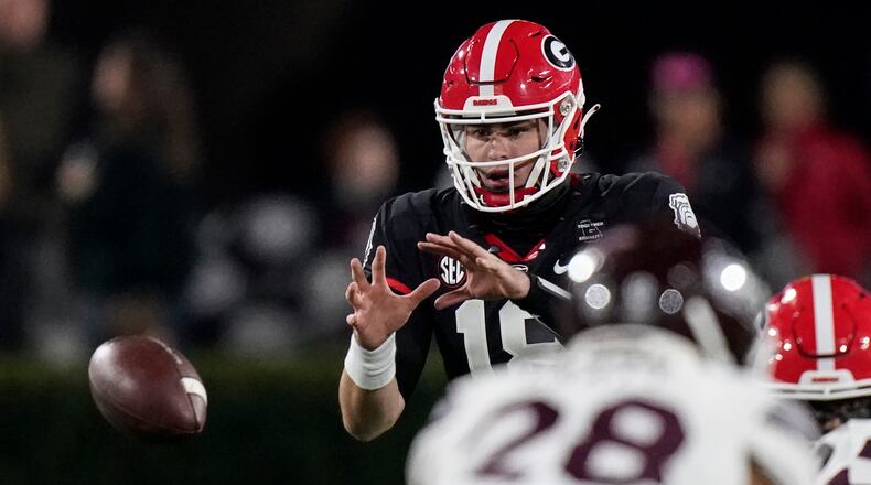 Georgia quarterback JT Daniels (18) catches the ball against Georgia in the first half Saturday, Nov. 21, 2020, in Athens. (Brynn Anderson/AP)