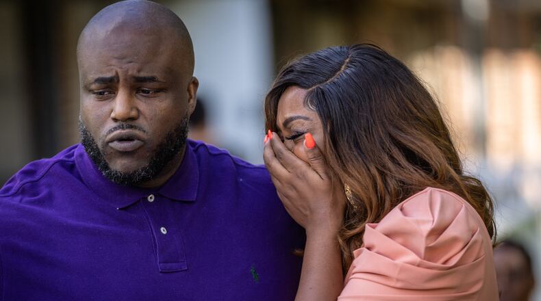 The parents of Nygil Cullins, Dr. Mya Speller Cullins (right) and Quinten Cullins, become emotional while talking at a news  conference Friday.