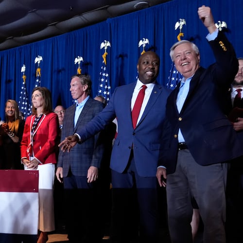 FILE - Republican presidential candidate former President Donald Trump speaks as Sen. Tim Scott, R-S.C., and Sen. Lindsey Graham, R-S.C., listen, at a primary election night party at the South Carolina State Fairgrounds in Columbia, S.C., Feb. 24, 2024. (AP Photo/Andrew Harnik, File)