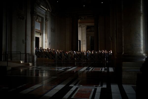 People line up as they enter St. Peter's Basilica to pay their respects to Pope Francis lying in state, at the Vatican, Thursday, April 24, 2025. (AP Photo/Emilio Morenatti)
