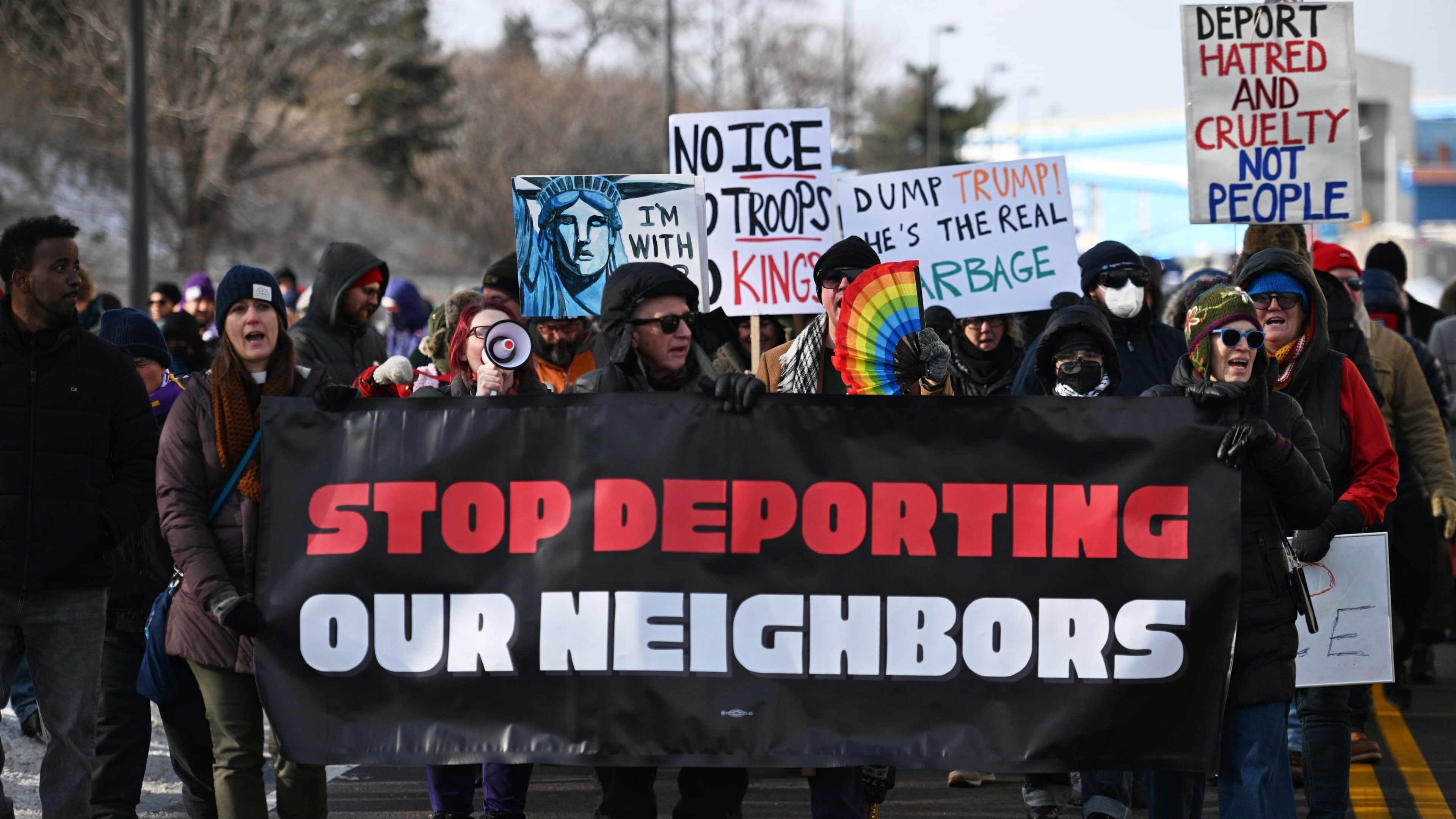 Protesters gather at a rally for immigrant and worker outside Signature Aviation near the Minneapolis–Saint Paul International Airport, Wednesday, Dec 3, 2025, in Minneapolis. (AP Photo/Tom Baker)