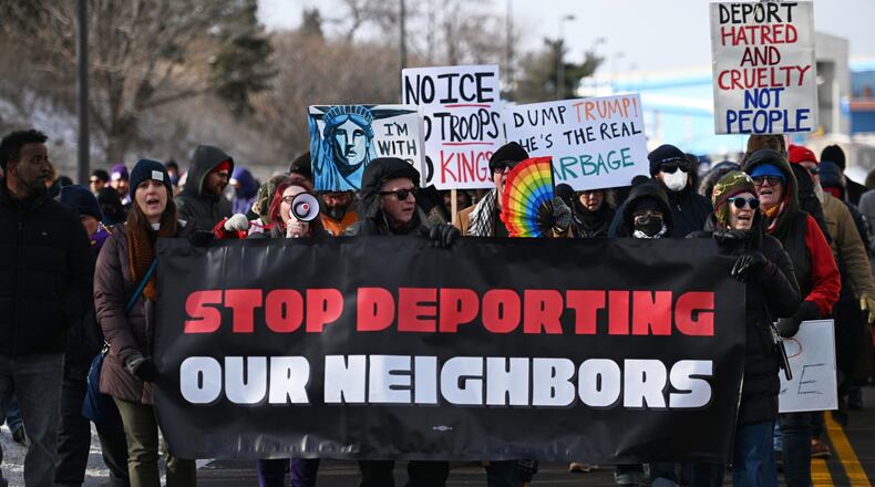 Protesters gather at a rally for immigrant and worker outside Signature Aviation near the Minneapolis–Saint Paul International Airport, Wednesday, Dec 3, 2025, in Minneapolis. (AP Photo/Tom Baker)