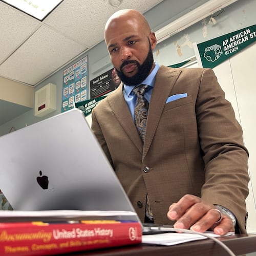 Leon Smith, named the 2026 National Teacher of the Year, stands in front of his classroom at Haverford High School, in Havertown, Pa. on Monday, April 20, 2026. (AP Photo/Tassanee Vejpongsa)