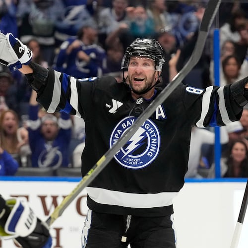 Tampa Bay Lightning right wing Nikita Kucherov (86) celebrates after picking up assist for his 1,000th career point on a goal by center Brayden Point during the second period of an NHL hockey game against the Anaheim Ducks Saturday, Oct. 25, 2025, in Tampa, Fla. (AP Photo/Chris O'Meara)