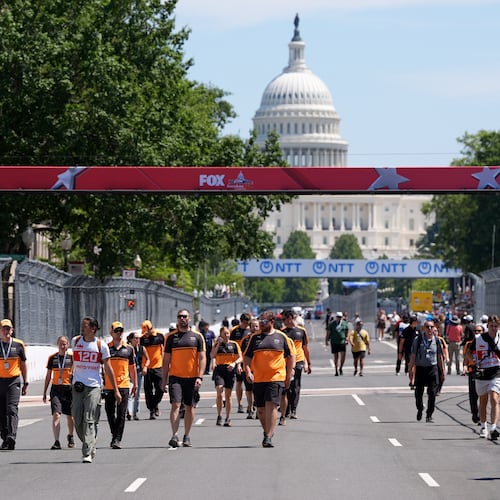 Racing teams walk the track before Sunday's Freedom 250 Grand Prix auto race, seen Friday, Aug. 21, 2026, in Washington. (AP Photo/Alex Brandon)