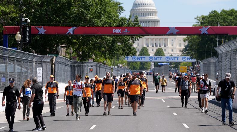 Racing teams walk the track before Sunday's Freedom 250 Grand Prix auto race, seen Friday, Aug. 21, 2026, in Washington. (AP Photo/Alex Brandon)
