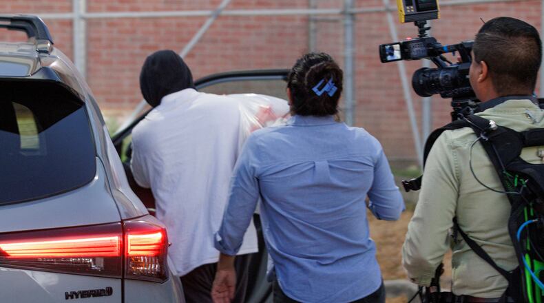 Immigration and Customs Enforcement officer Christian Castro gets into a car surrounded by news reporters moments after being released from the Carrizalez-Rucker Cameron County Detention Center in Brownsville, Texas on Thursday, Aug. 27, 2026. (AP Photo/Michael Gonzalez)