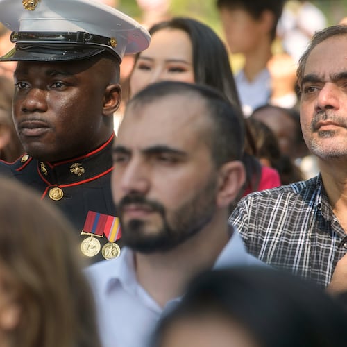 U.S. Marine Sgt. Diakaria Sangare, center, from Guinea, salutes the playing of the national anthem at a naturalization ceremony on Independence Day at George Washington's Mount Vernon, Saturday, July 4, 2026, in Alexandria, Va. (AP Photo/Rod Lamkey, Jr.)