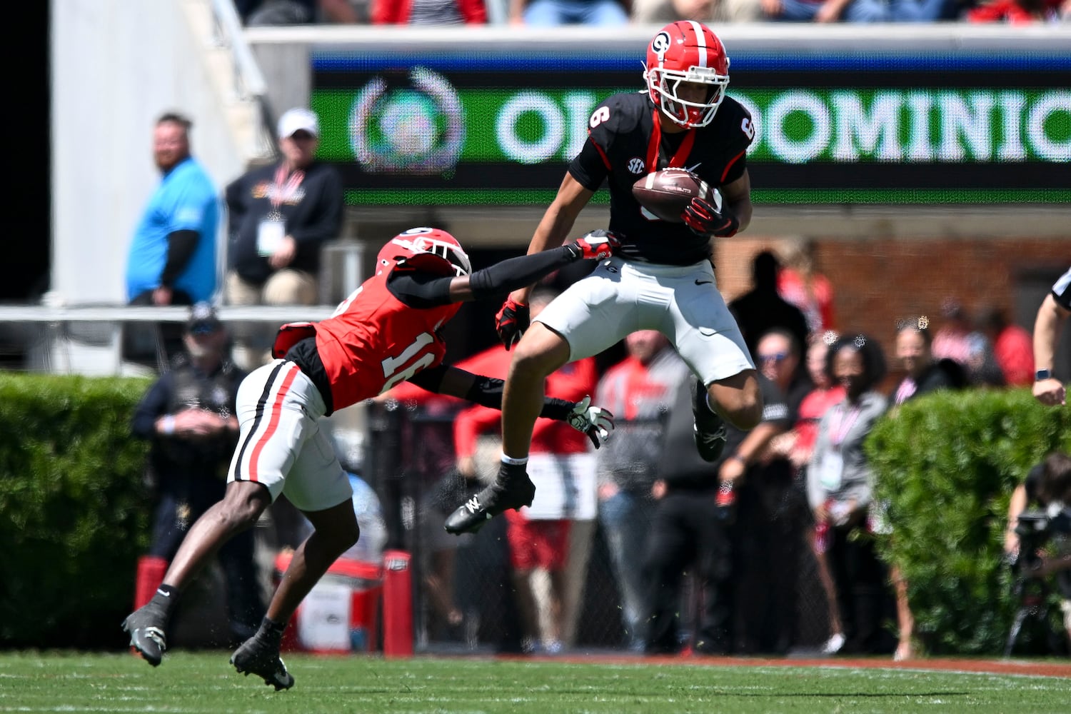 Georgia’s Black Team’s CJ Wiley (6) makes a leaping catch over Georgia’s Red Team’s Maurice Hayes (18) during the first half of the G-Day spring football game Saturday, April 12, 2025 at Sanford Stadium in Athens. (Daniel Varnado/For the Atlanta Journal-Constitution)