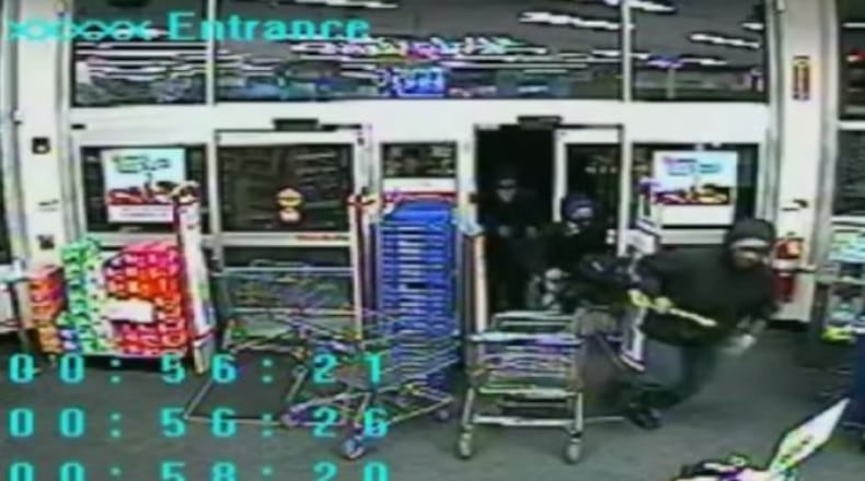 Thieves are seen on surveillance video breaking through the front door of the Walgreens on Eagles Landing Parkway in Stockbridge. (Credit: Channel 2 Action News)