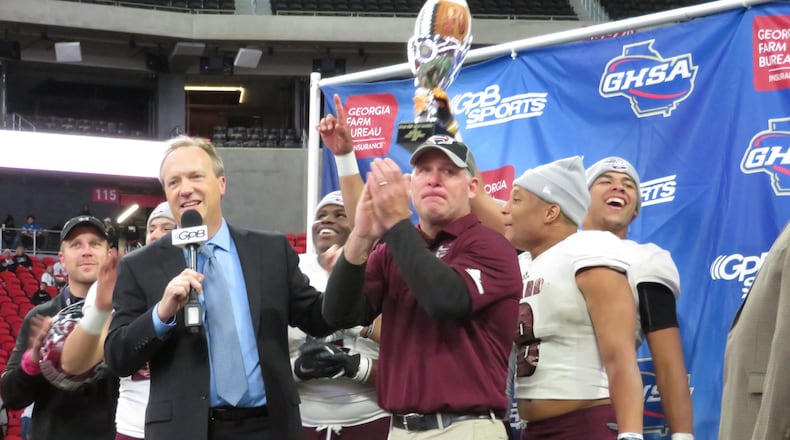 Heard County Braves coach Tim Barron claps as his players hoist the Class AA state championship trophy following their 27-6 win over the Rockmart Yellow Jackets on Wednesday, Dec. 12, 2018 at Mercedes-Benz Stadium. (Adam Krohn/special)