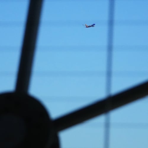 A Southwest Airlines airplane is seen through the structure at Reunion Tower as it flies over Dallas after taking off from Dallas Love Field Airport Thursday, Nov. 6, 2025. (AP Photo/Julio Cortez)