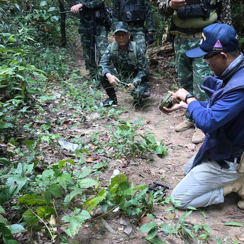 In this photo released by the Royal Thai Army, a Thai officer inspects a landmine near the Thai-Cambodia border in Sisaket province, Thailand, Monday, Nov. 10, 2025. (Royal Thai Army via AP)