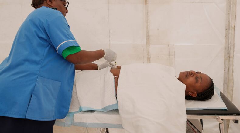 A nurse administers lenacapavir to Tambudzai Ndlovu during the launch of the new HIV prevention drug in Harare, Zimbabwe, Thursday, Feb. 19, 2026. (AP Photo/Aaron Ufumeli)