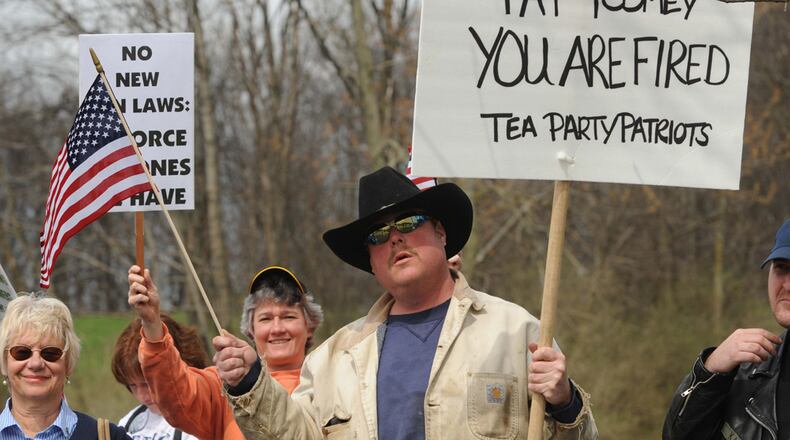 Tea Party protestor Greg Hetherington holds a sign during a second amendment protest rally held outside Senator Pat Toomey's Johnstown, Pa. office on Tuesday, April 16, 2013. (AP Photo/The Tribune-Democrat, Todd Berkey) THE MORNING CALL OUT; DAILY AMERICAN OUT; WJAC-TV OUT