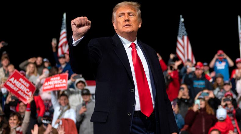 US President Donald Trump holds up his fist as he leaves the stage at the end of a rally to support Republican Senate candidates at Valdosta Regional Airport in Valdosta, Georgia on December 5, 2020. (ANDREW CABALLERO-REYNOLDS/AFP via Getty Images/TNS)