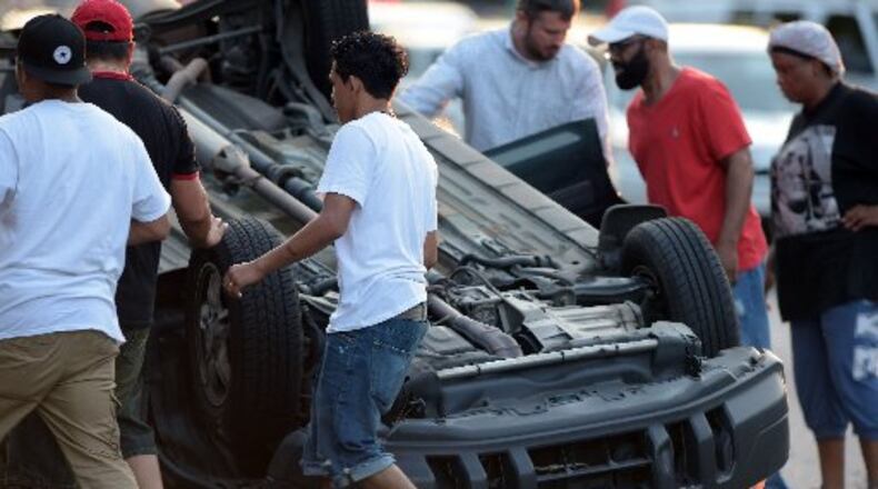 Dunwoody police and DeKalb Fire Rescue respond to a vehicle wreck with an overturned SUV that closed several lanes of I-285 shortly after 8 p.m. Wednesday, August 3, 2016. KENT D. JOHNSON/KDJOHNSON@AJC.COM