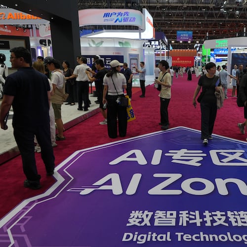 Visitors tour the exhibition booths operated with Artificial Intelligence (AI) at the China International Supply Chain Expo in Beijing on June 25, 2026. (AP Photo/Andy Wong)