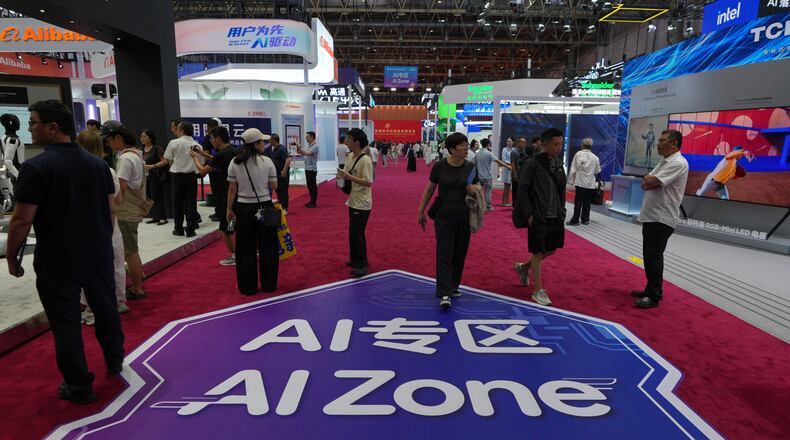 Visitors tour the exhibition booths operated with Artificial Intelligence (AI) at the China International Supply Chain Expo in Beijing on June 25, 2026. (AP Photo/Andy Wong)