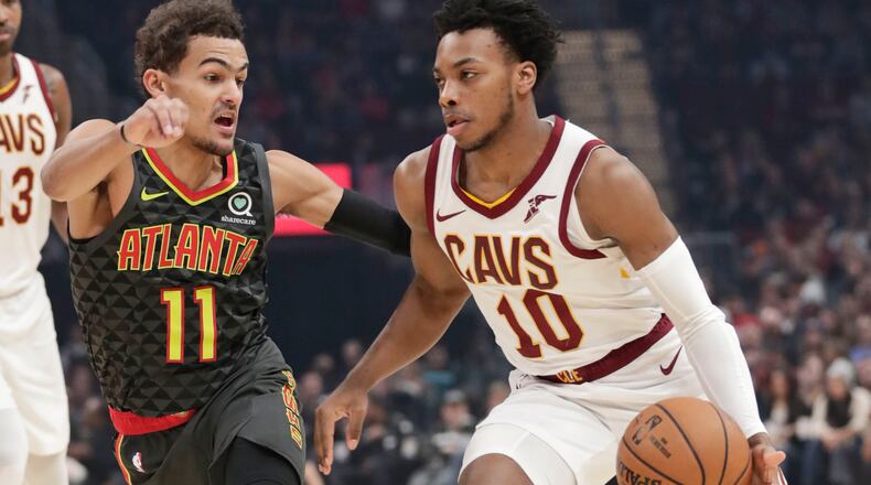 Cavaliers guard Darius Garland (10) drives against Trae Young of the Hawks during the first half of Monday's game in Cleveland. (AP Photo/Tony Dejak)