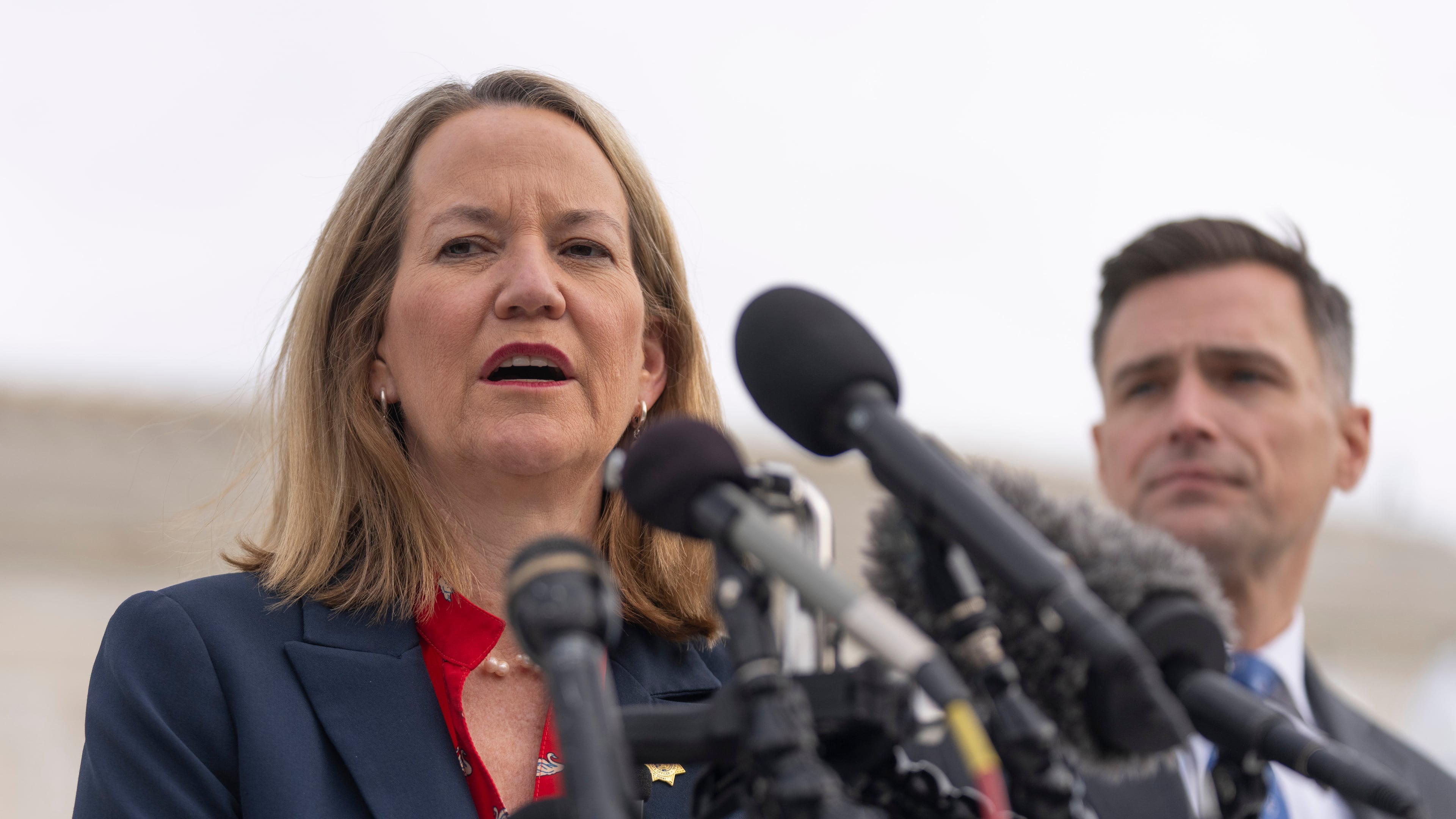 Arizona Attorney General Kris Mayes speaks to reporters as Oregon Attorney General Dan Rayfield listens outside the Supreme Court on Wednesday, Nov. 5, 2025, in Washington. (AP Photo/Mark Schiefelbein)