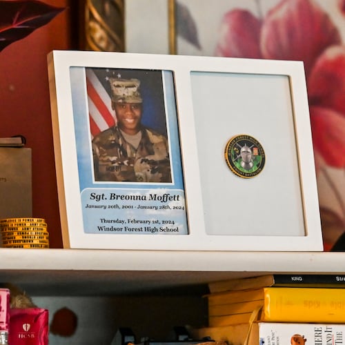 Mementos of Sgt. Breonna Moffett line a shelf at Francine and Percell Moffett's family home in Savannah. (Sarah Peacock for the AJC)