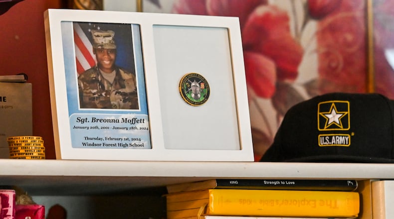 Mementos of Sgt. Breonna Moffett line a shelf at Francine and Percell Moffett's family home in Savannah. (Sarah Peacock for the AJC)