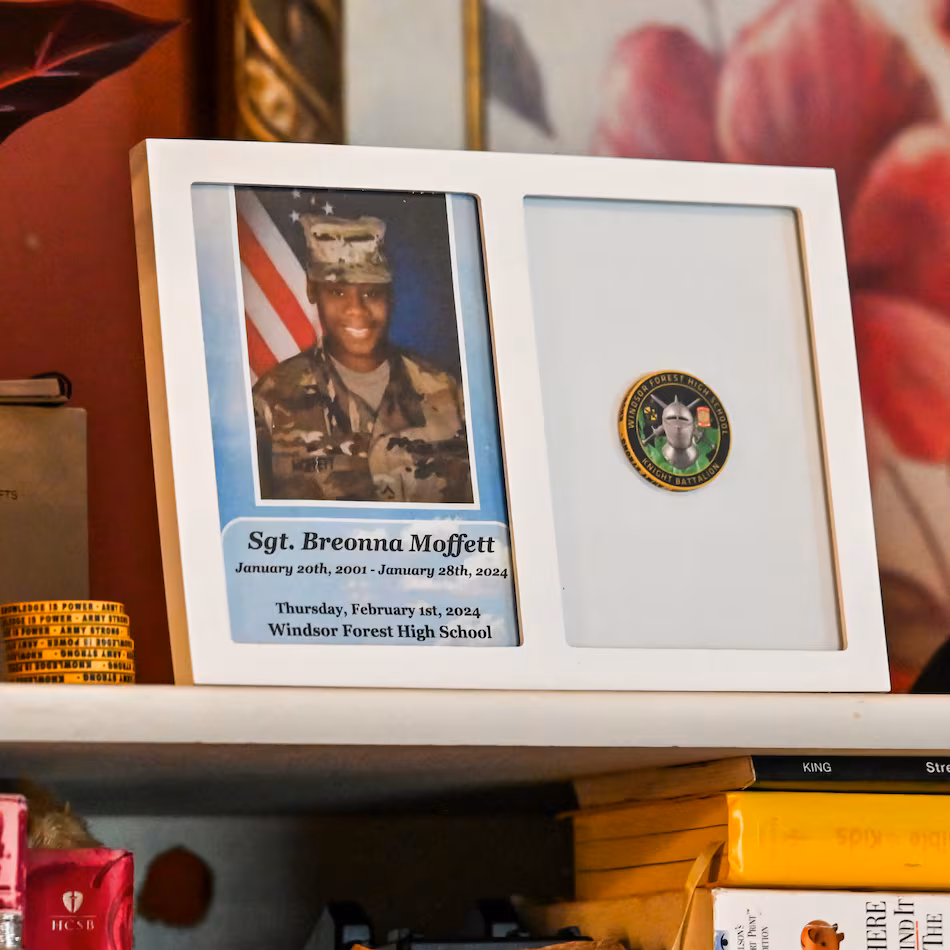Mementos of Sgt. Breonna Moffett line a shelf at Francine and Percell Moffett's family home in Savannah. (Sarah Peacock for the AJC)