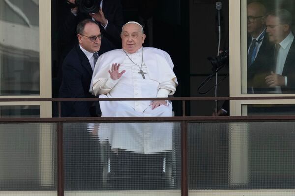 FILE - Pope Francis waves as he appears at a window of the Agostino Gemelli Polyclinic in Rome, Sunday, March 23, 2025, where he has been treated for bronchitis and bilateral pneumonia since Feb. 14. (AP Photo/Andrew Medichini, File)