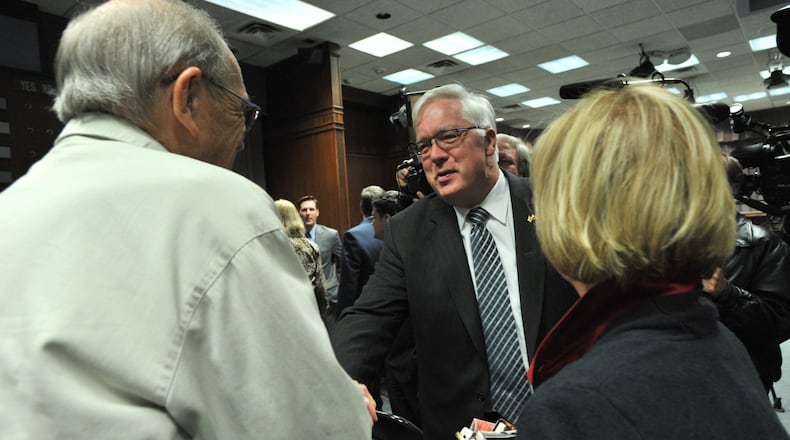 Cobb County Chairman Tim Lee celebrates with supporters after wriggling out of an ethics complaint with a quasi-apology. HYOSUB SHIN / HSHIN@AJC.COM