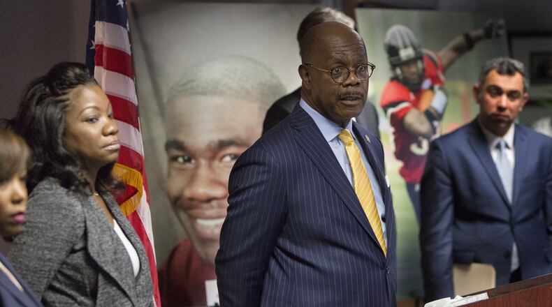 Monteria Robinson (left) listens as Fulton County District Attorney Paul L. Howard, Jr., announces the filing of a lawsuit against the United States Department of Justice in the death of her son Jamarion Robinson during a press conference on December 28th, 2018. (Photo by Phil Skinner)